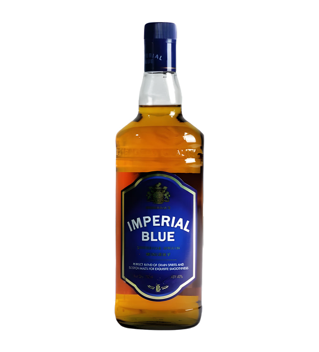 Imperial Blue Indian Whisky 750ml clear glass bottle on white background, golden amber spirit with blue and gold label featuring brand crest and bold logo