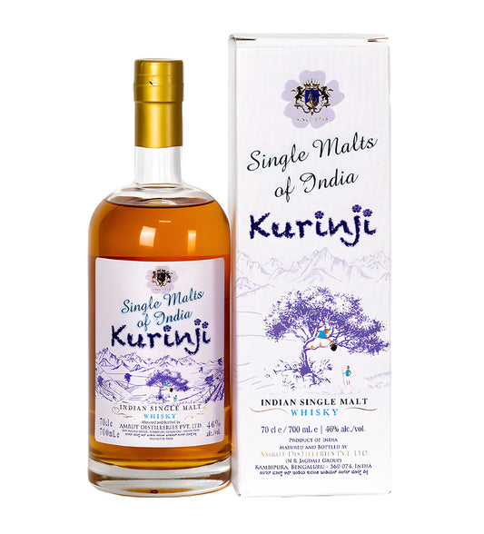 Amrut India Kurinji Indian Single Malt Whisky 70cl clear glass bottle on white background, golden amber spirit with deep blue and gold label inspired by Kurinji flower and landscape motif