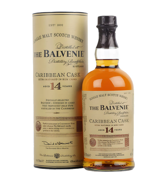 The Balvenie 14 Years Peated Triple Cask Single Malt Scotch Whisky 70cl clear glass bottle on white background, golden amber spirit with cream and gold label featuring distillery crest and age statement