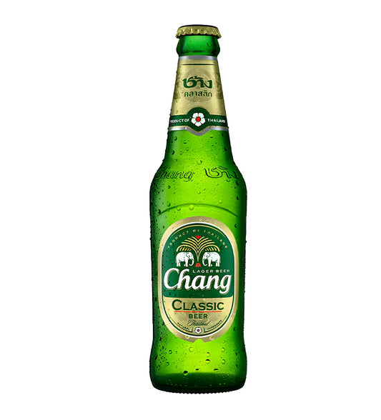 Chang Classic Thai lager beer 32cl glass bottle on white background, green and gold label with elephant logo