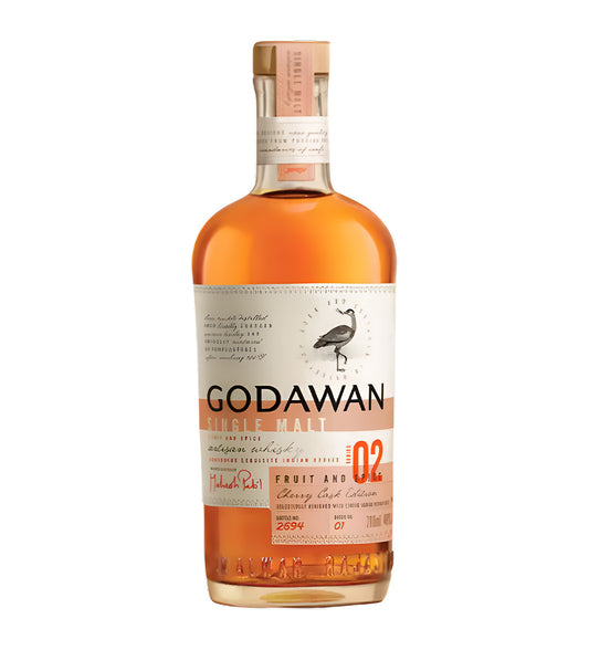 Godawan Fruit & Spice Indian Single Malt Whisky 70cl clear glass bottle on white background, rich amber spirit with cream label featuring bird illustration and orange accents