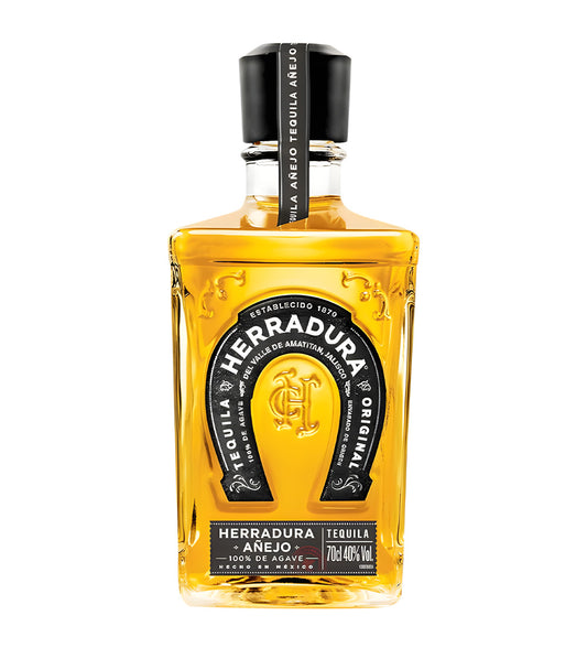 Herradura Añejo Tequila 70cl clear glass bottle on white background, rich amber spirit with gold horseshoe logo and white label featuring agave imagery