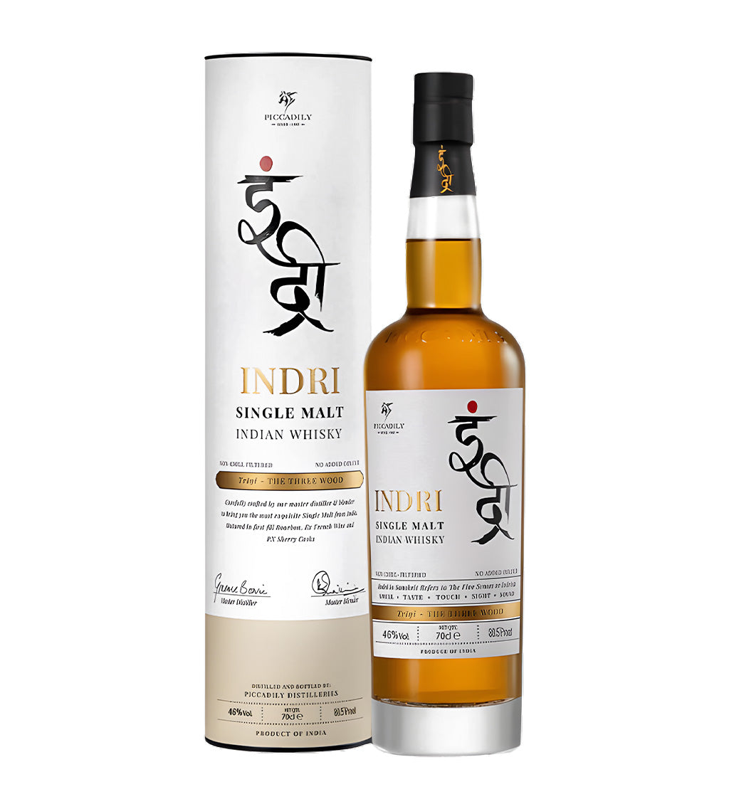 Indri Single Malt Indian Whisky 70cl clear glass bottle on white background, golden amber spirit with black and gold label featuring brand logo