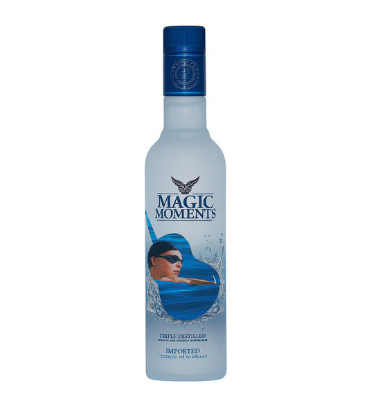 Bottle of 'Magic Moments' vodka with a blue cap and label featuring an underwater scene.